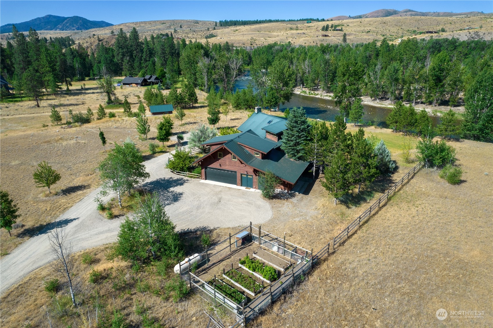 16 Lewisia Road Winthrop, WA 98862 - Photo 1 of 40 an aerial view of a house with lake view