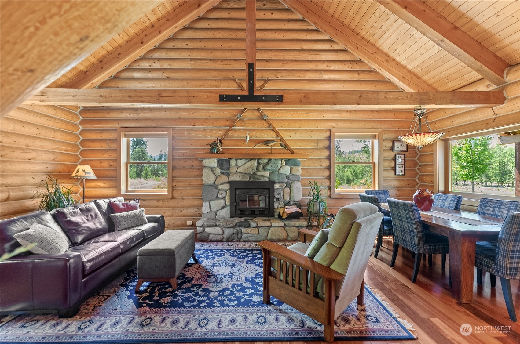 16 Lewisia Road Winthrop, WA 98862 - Photo 14 of 40 a living room with furniture a fireplace and a large window