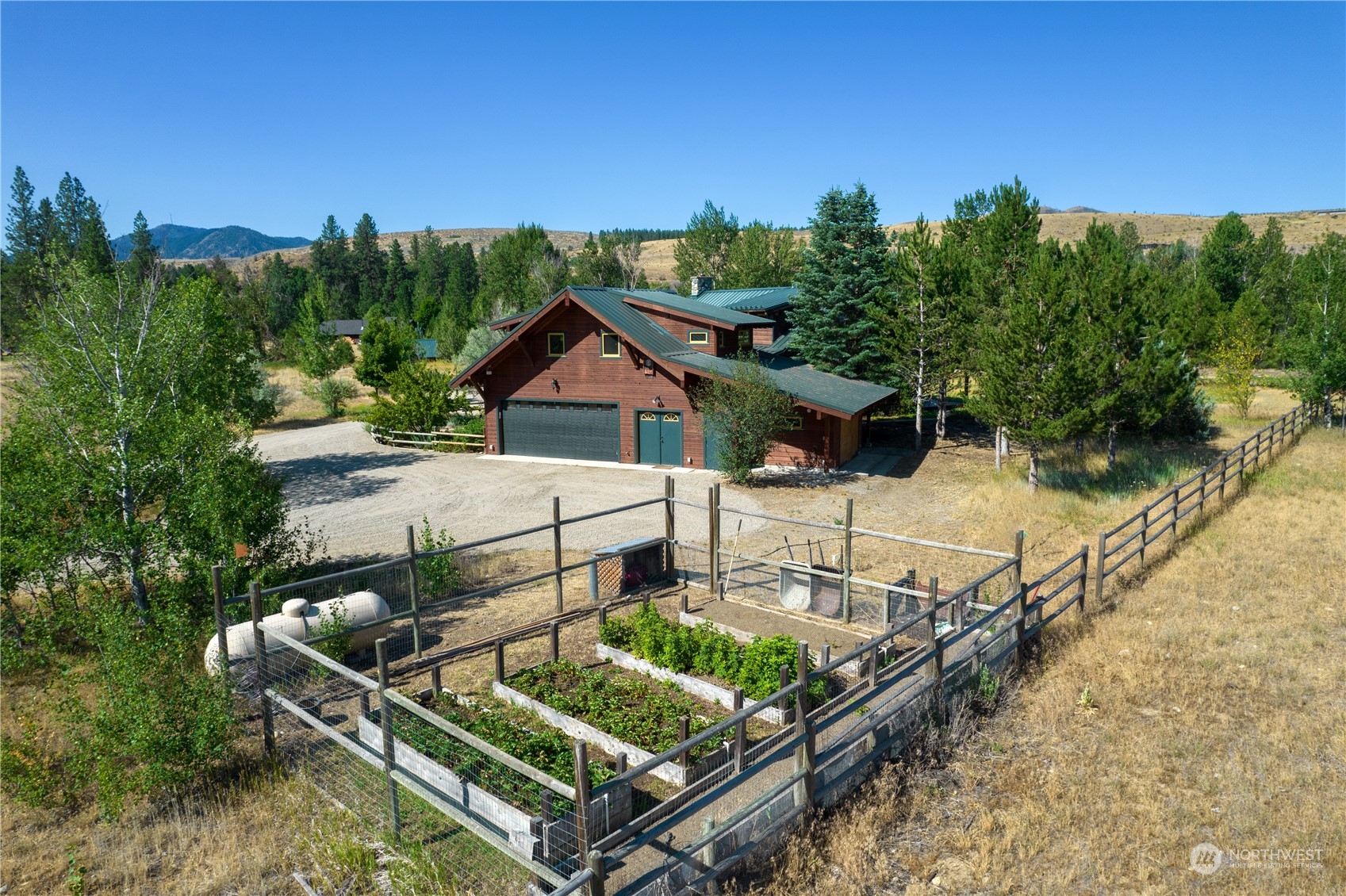 16 Lewisia Road Winthrop, WA 98862 - Photo 18 of 40 a roof deck with table and chairs a barbeque and potted plants
