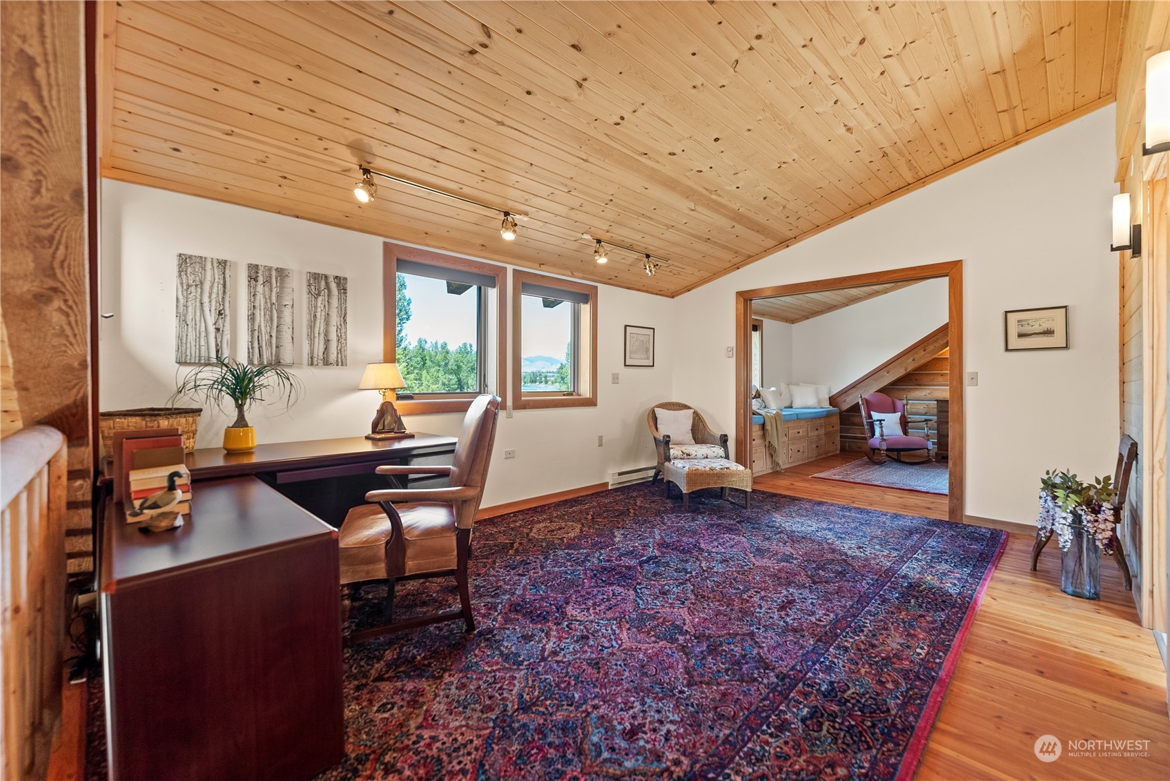 16 Lewisia Road Winthrop, WA 98862 - Photo 29 of 40 a living room with furniture a dining table and a fireplace