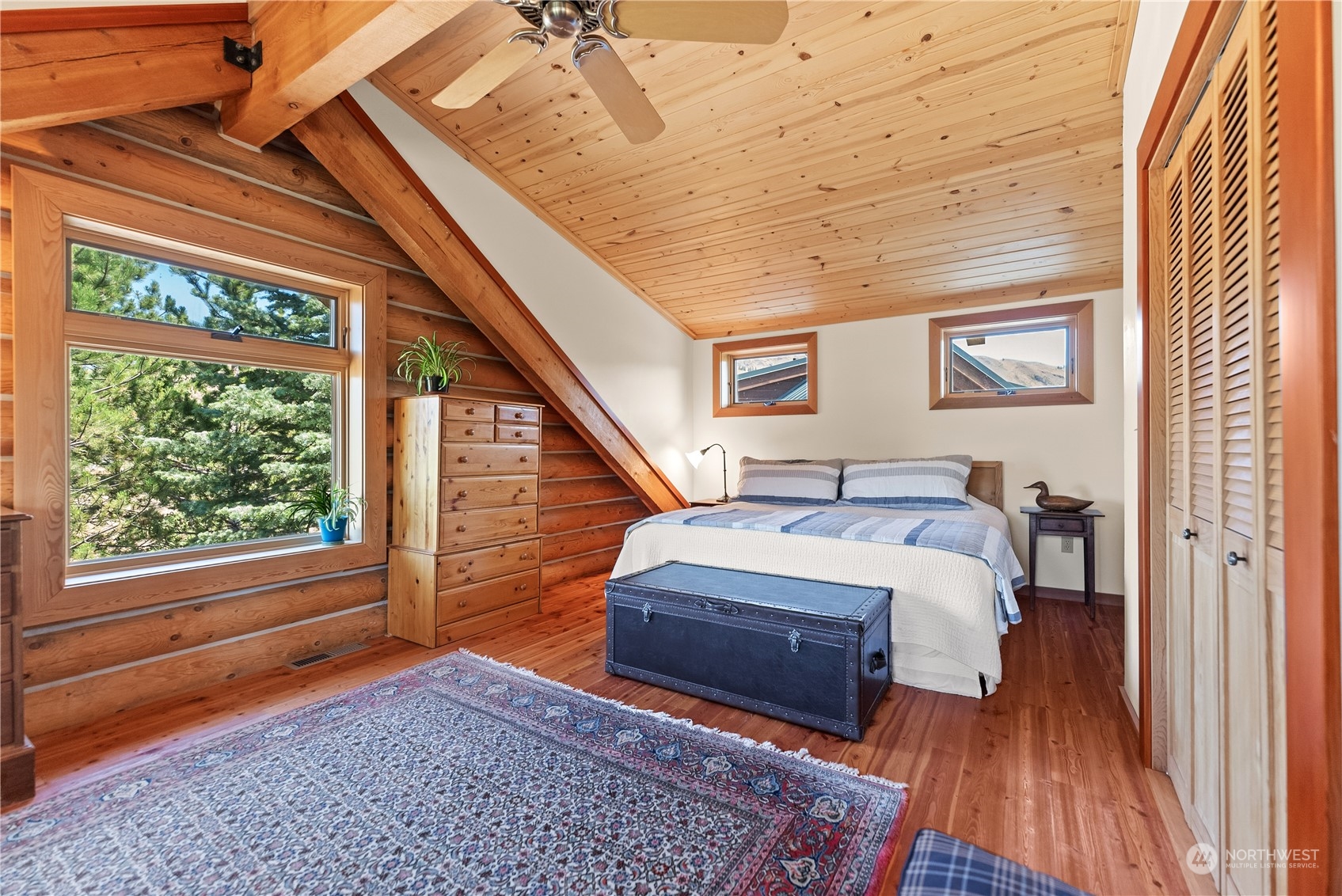 16 Lewisia Road Winthrop, WA 98862 - Photo 35 of 40 a bedroom with a bed and wooden floor