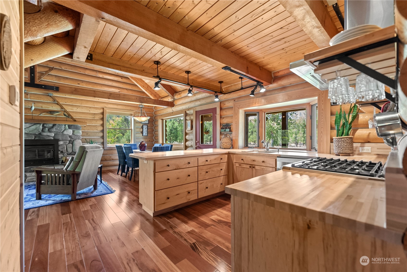 16 Lewisia Road Winthrop, WA 98862 - Photo 10 of 40 a kitchen with sink cabinets and a wooden floor