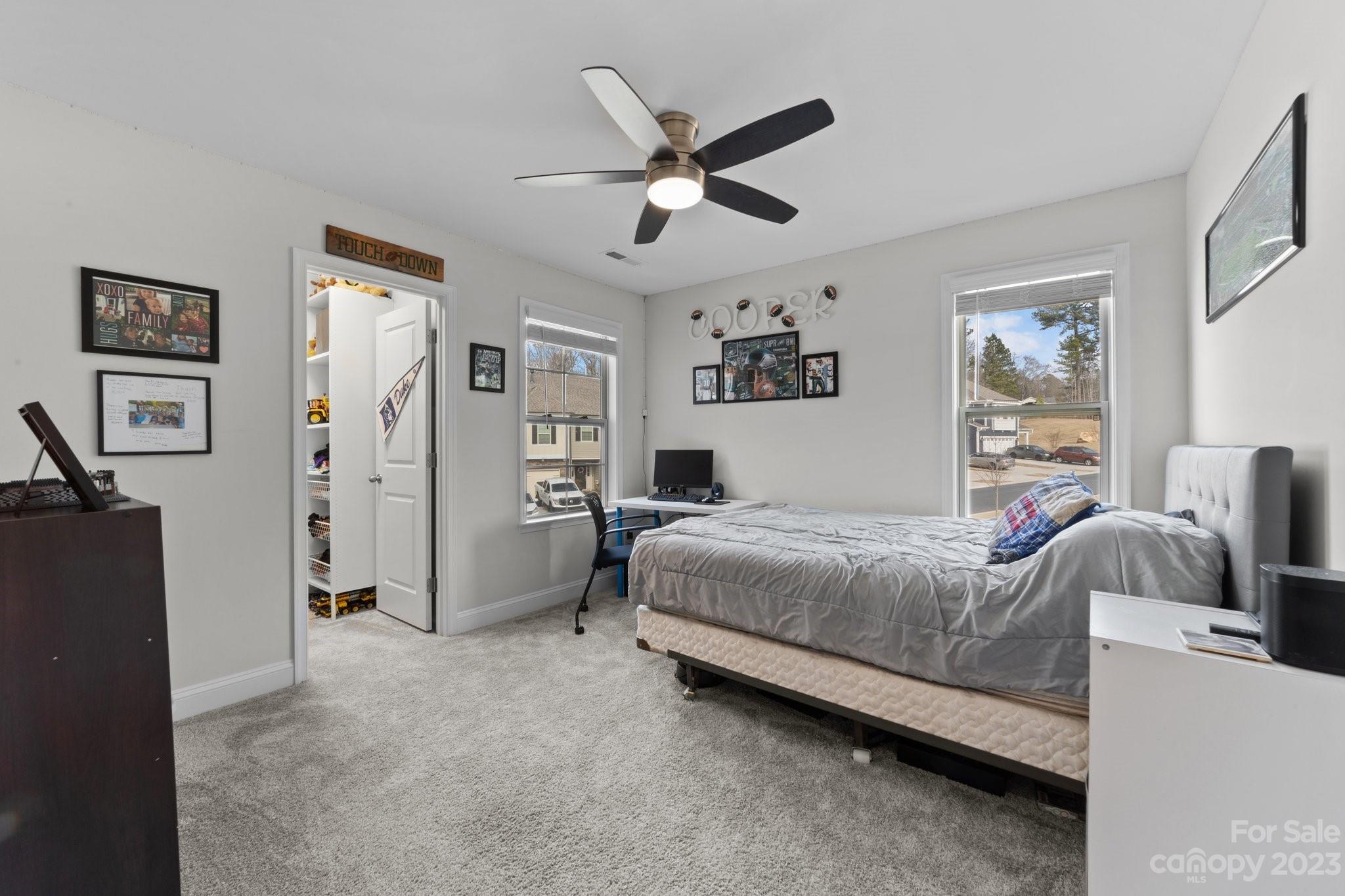 2041 Suttonview Road Fort Mill, SC 29708 - Photo 19 of 27 a bedroom with a bed and ceiling fan