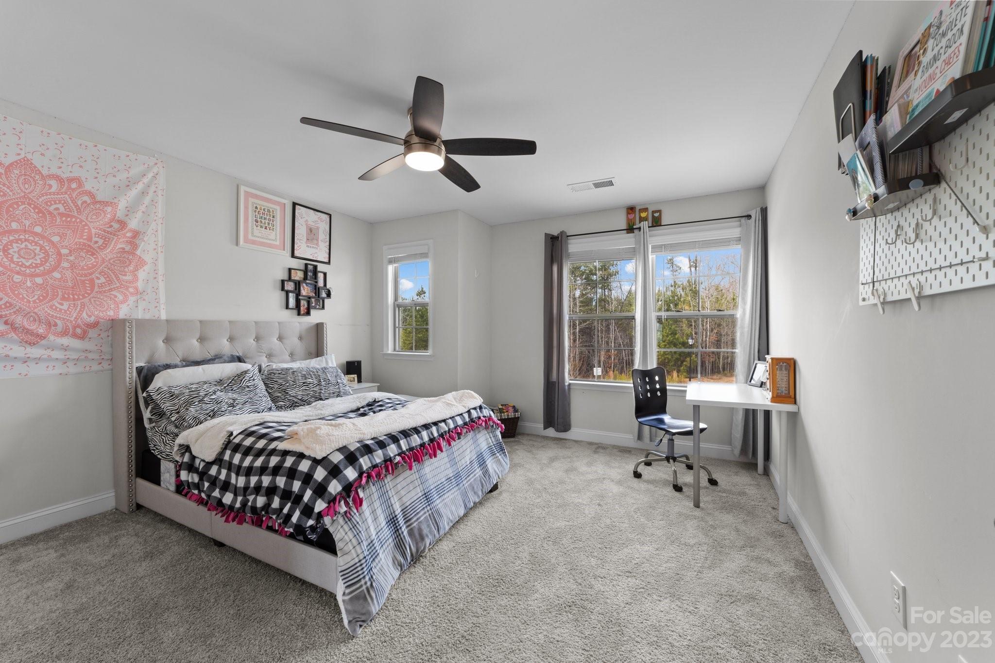 2041 Suttonview Road Fort Mill, SC 29708 - Photo 20 of 27 a bedroom with a bed a table and a large window
