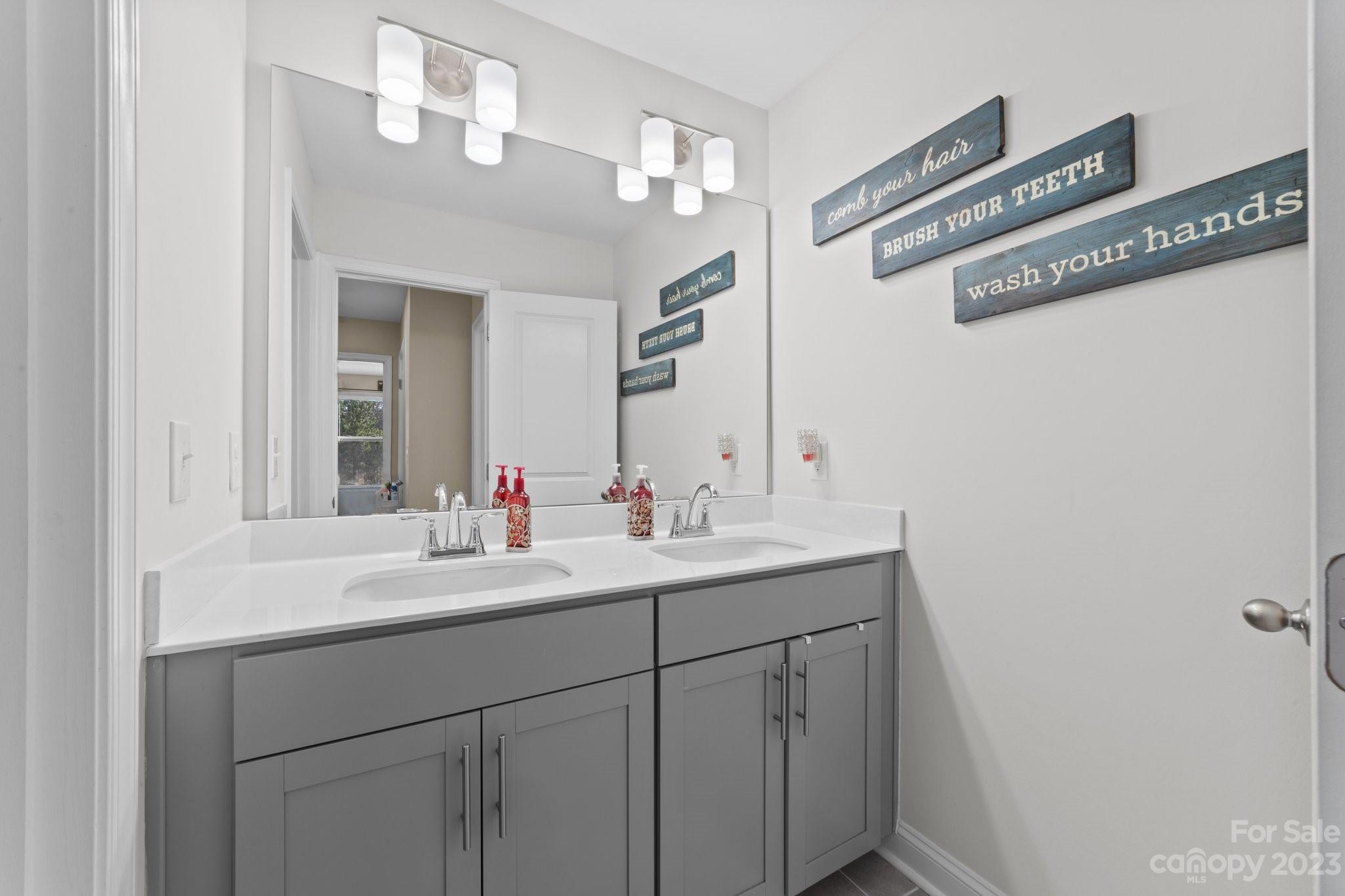2041 Suttonview Road Fort Mill, SC 29708 - Photo 21 of 27 a bathroom with a sink and a mirror