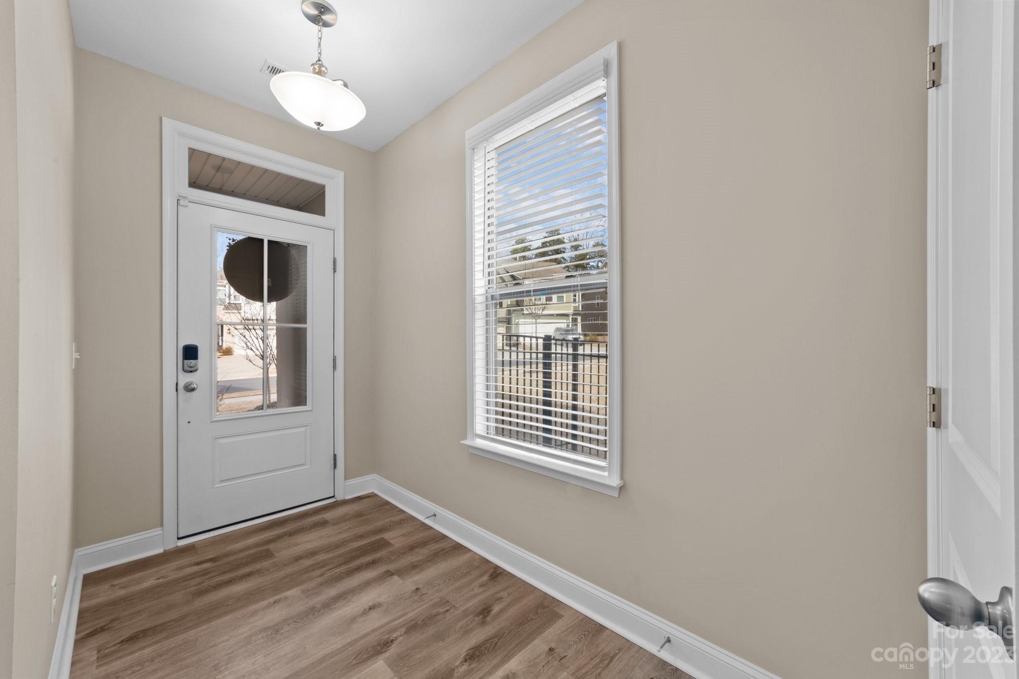 2041 Suttonview Road Fort Mill, SC 29708 - Photo 4 of 27 a view of an empty room with wooden floor and a window