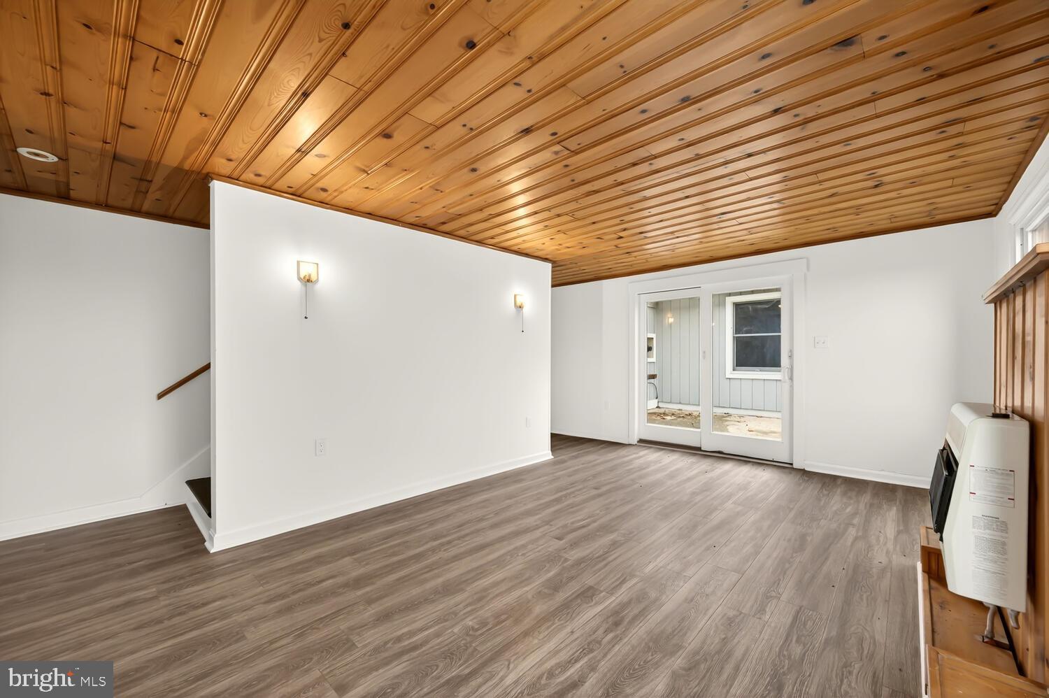 6746 Quaker Neck Road Chestertown, MD 21620 - Photo 37 of 50 a view of an empty room with wooden floor and a window
