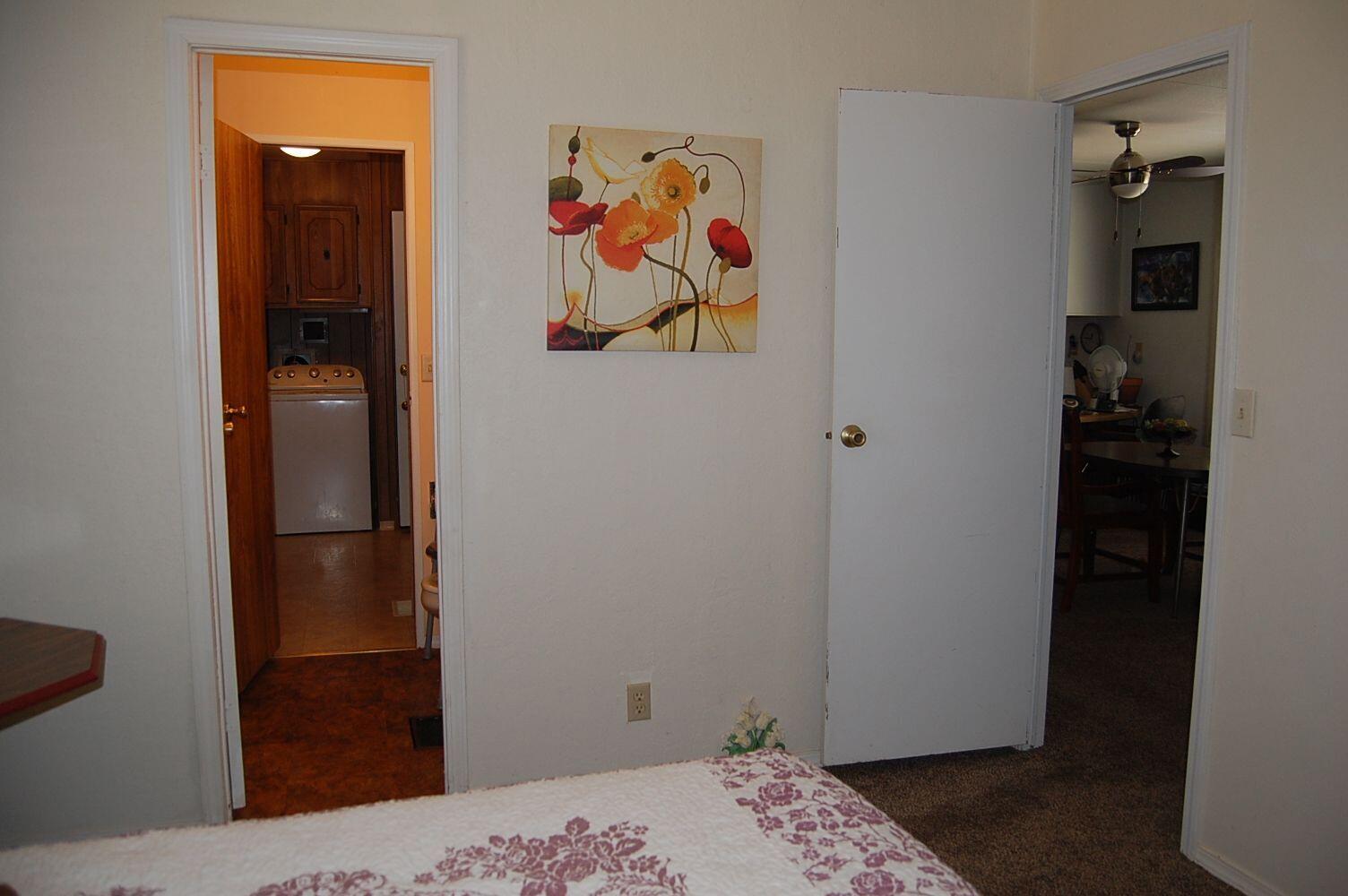 350 Hamilton Avenue Cave Junction, OR 97523 - Photo 15 of 23 a bedroom with a bed and a view of bathroom
