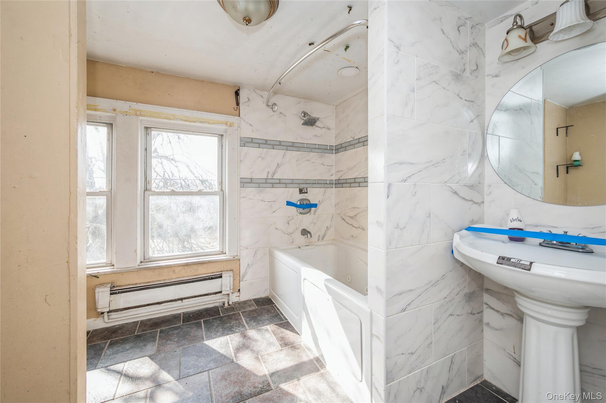 5 Church Street Baldwin, NY 11510 - Photo 17 of 32 a bathroom with a sink a toilet and a shower