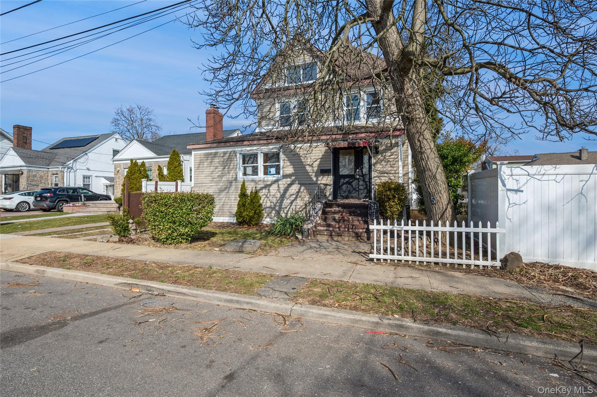 5 Church Street Baldwin, NY 11510 - Photo 2 of 32 a front view of a house with a garden