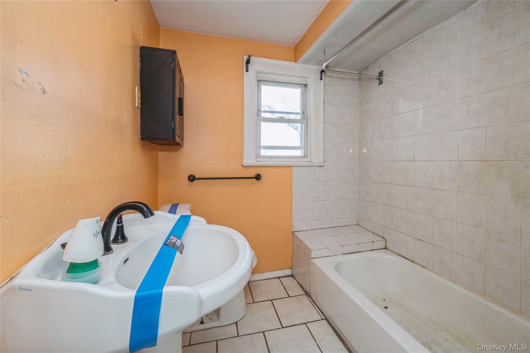 5 Church Street Baldwin, NY 11510 - Photo 25 of 32 a bathroom with a sink and bathtub