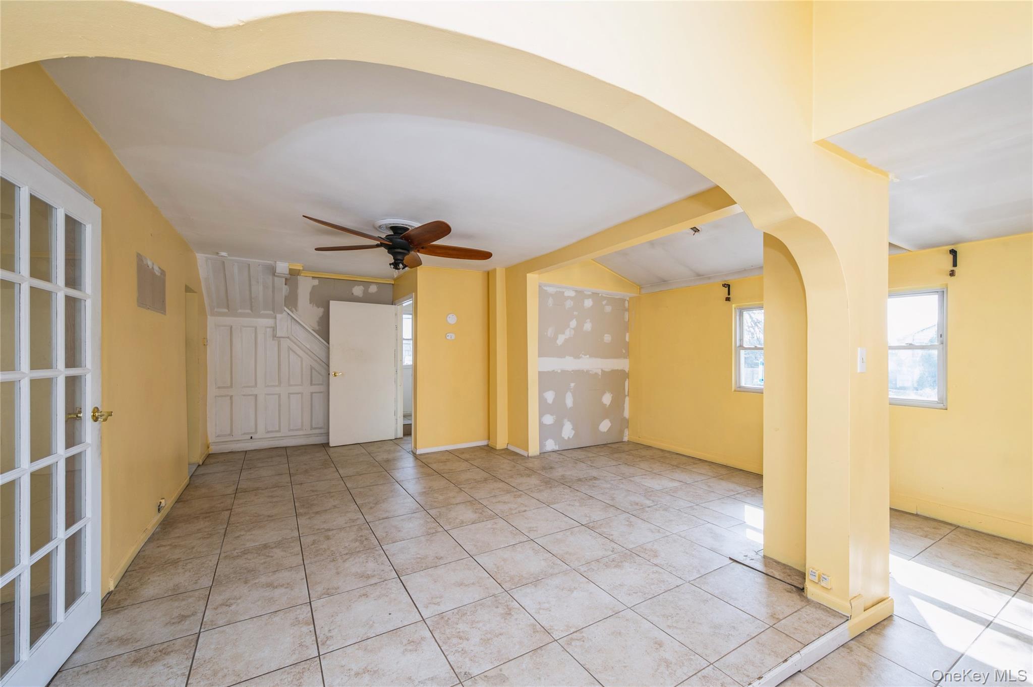 5 Church Street Baldwin, NY 11510 - Photo 7 of 32 a view of a big room with wooden floor and a ceiling fan