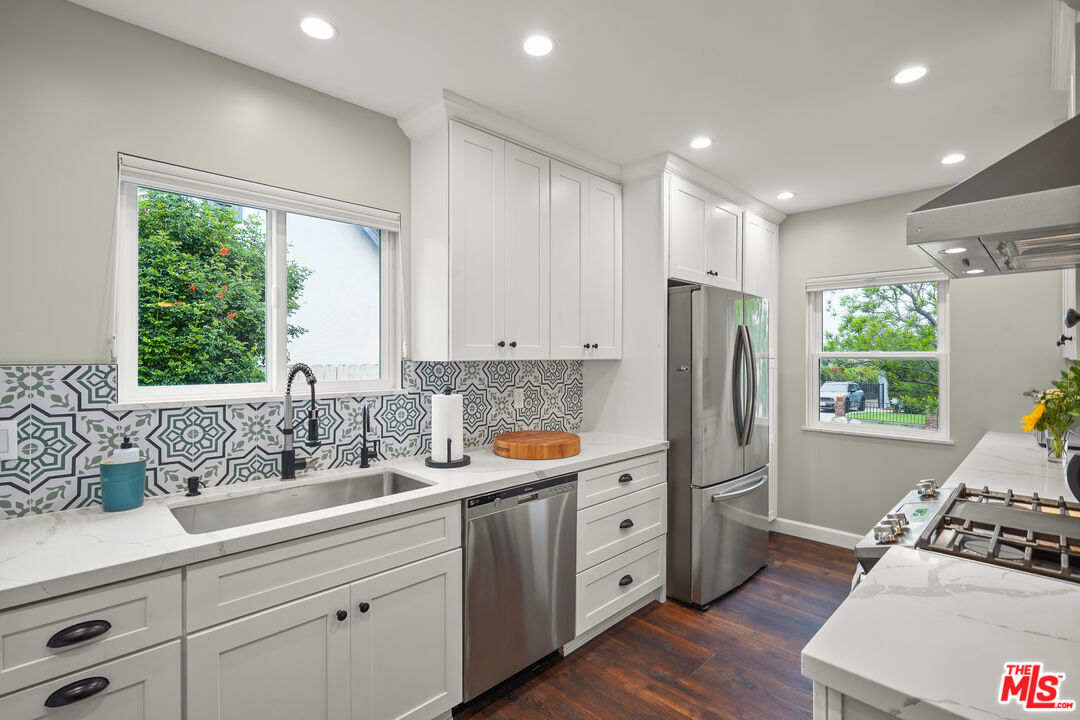 511 Crosby Street Altadena, CA 91001 - Photo 12 of 38 a kitchen with stainless steel appliances sink refrigerator and window