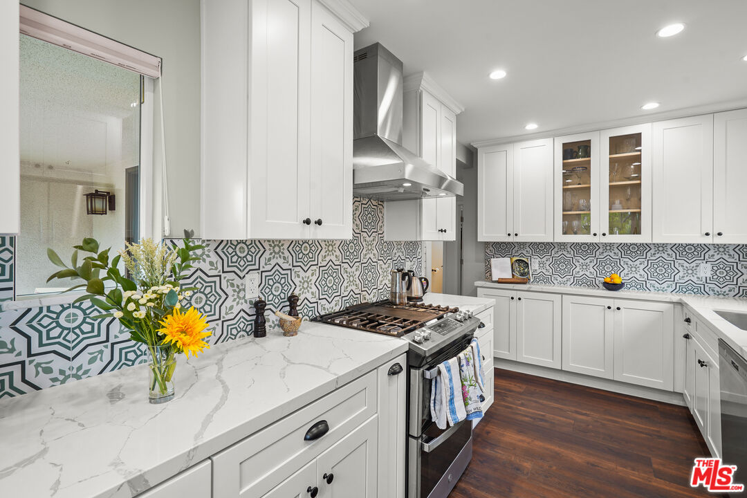 511 Crosby Street Altadena, CA 91001 - Photo 14 of 38 a kitchen with stainless steel appliances kitchen island granite countertop a sink a stove cabinets counter space and a window