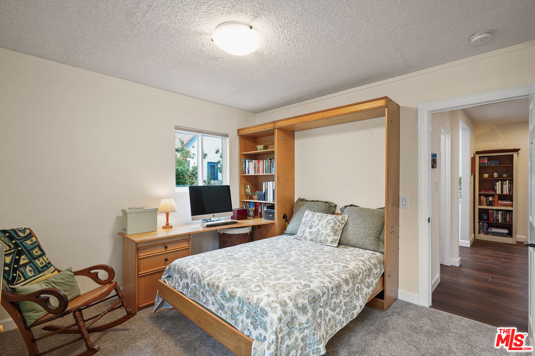 511 Crosby Street Altadena, CA 91001 - Photo 23 of 38 a bedroom with a bed and wooden floor