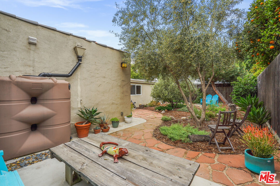 511 Crosby Street Altadena, CA 91001 - Photo 32 of 38 a backyard of a house with table and chairs potted plants