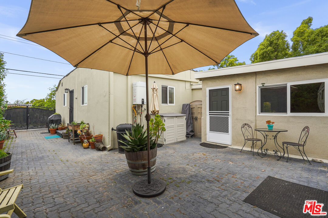 511 Crosby Street Altadena, CA 91001 - Photo 36 of 38 a view of a patio with table and chairs under an umbrella