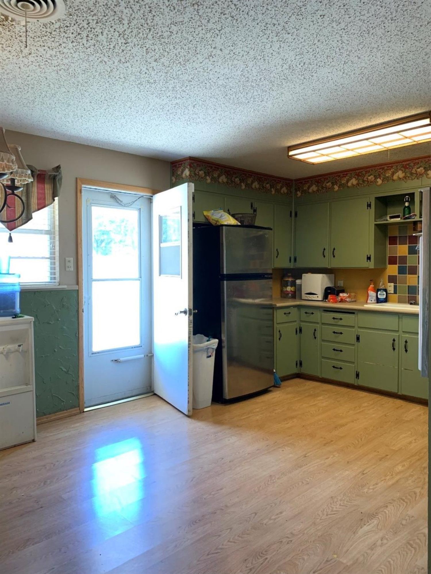 1208 Ave M Ralls, TX 79357 - Photo 13 of 22 a kitchen with stainless steel appliances a refrigerator sink and cabinets