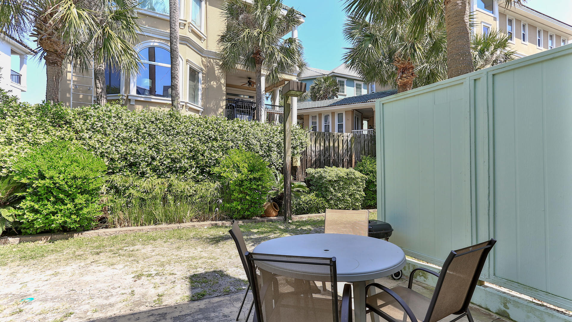 940 Highway 98, Unit 102 Destin, FL 32541 - Photo 13 of 18 a view of a table and chairs in patio of the house
