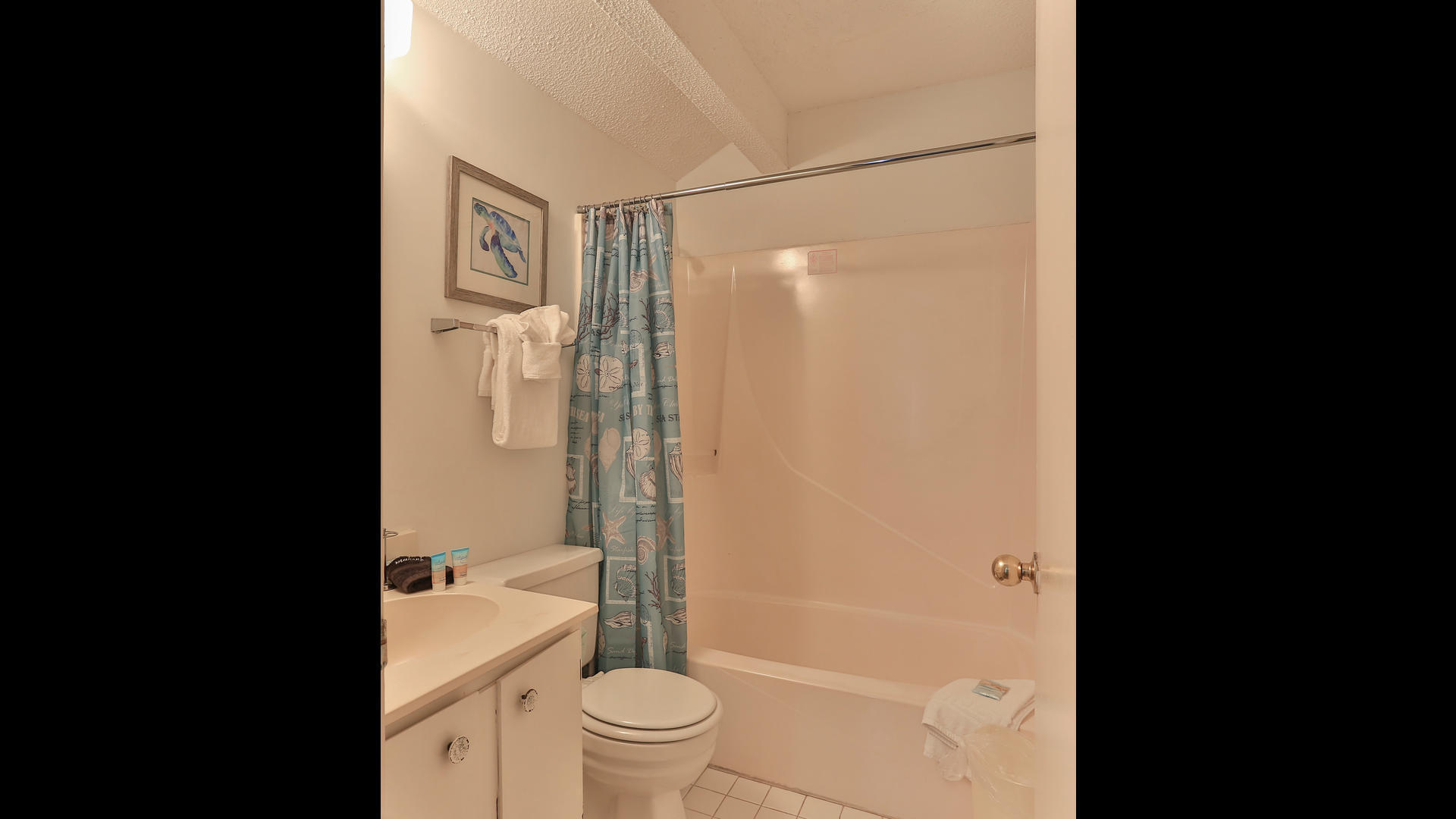 940 Highway 98, Unit 102 Destin, FL 32541 - Photo 18 of 18 a bathroom with a shower a toilet and a sink