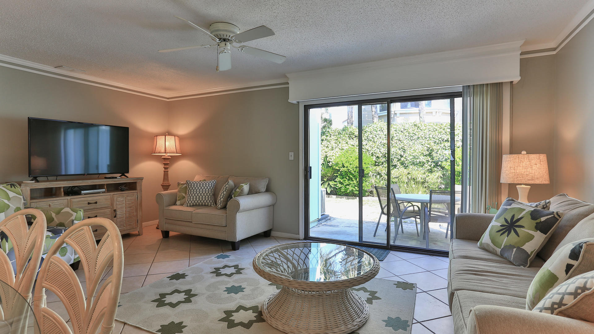 940 Highway 98, Unit 102 Destin, FL 32541 - Photo 3 of 18 a living room with furniture a flat screen tv and a large window