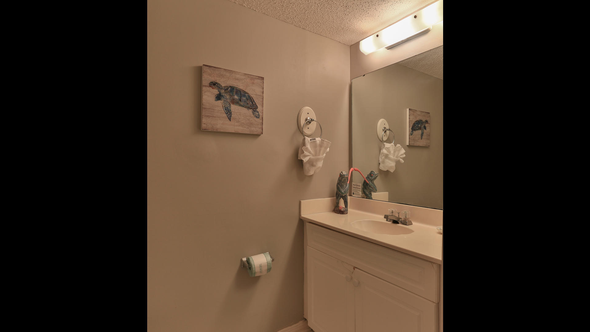 940 Highway 98, Unit 102 Destin, FL 32541 - Photo 8 of 18 a bathroom with a sink and a mirror