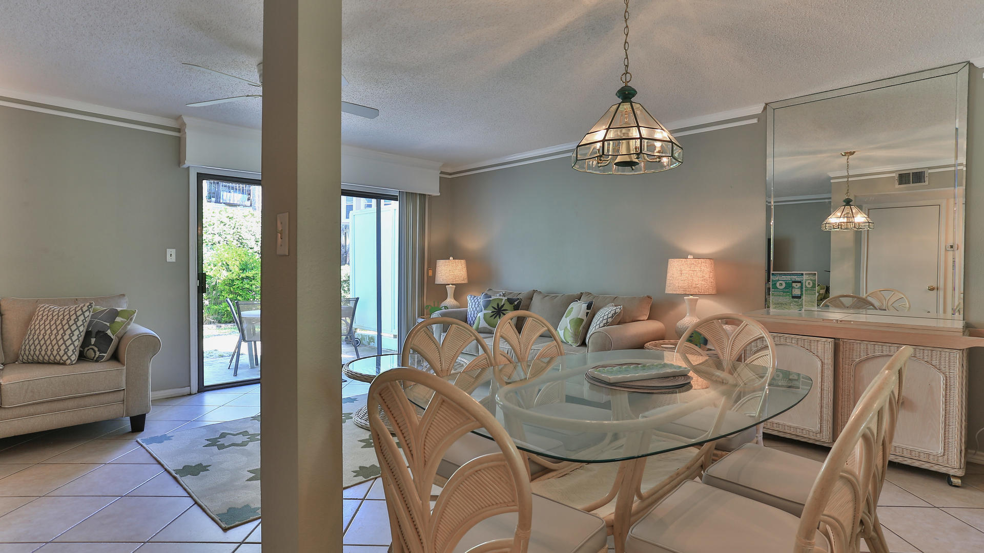 940 Highway 98, Unit 102 Destin, FL 32541 - Photo 9 of 18 a view of a dining room with furniture a chandelier and wooden floor