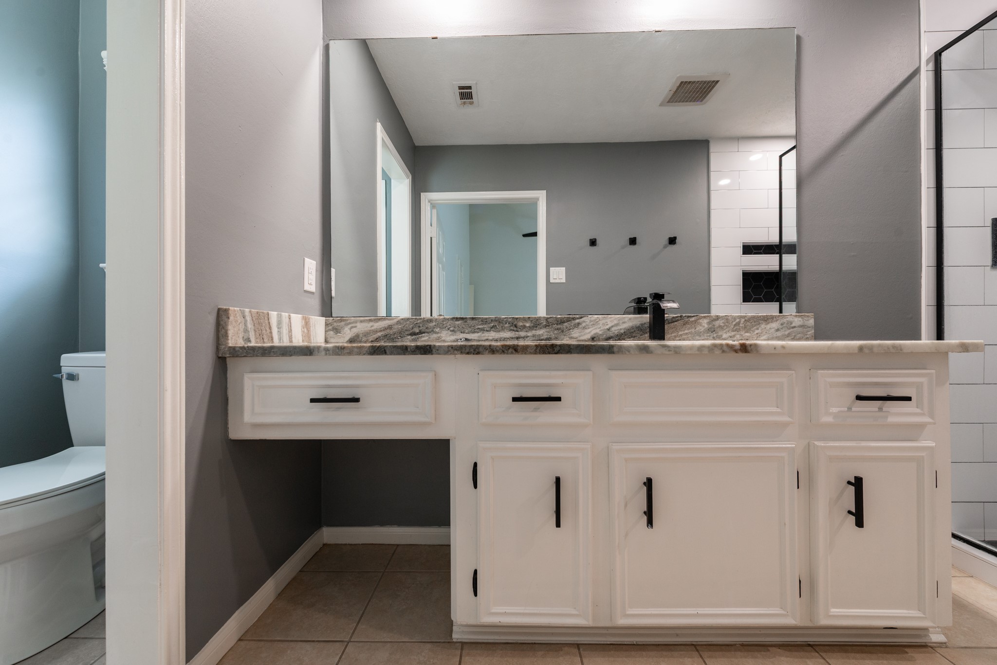 1022 White Sands Road Katy, TX 77450 - Photo 20 of 27 Upgraded granite countertops in primary bathroom featuring modern black finishes throughout.