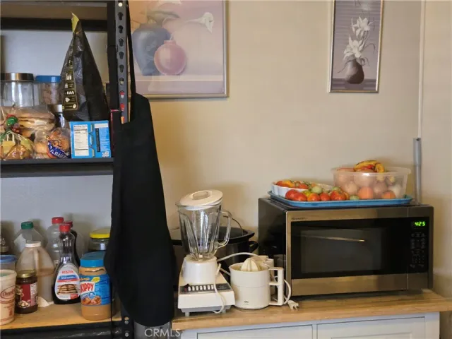a kitchen with sink refrigerator and cabinets