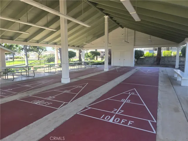 a view of a white house in a big yard with large trees