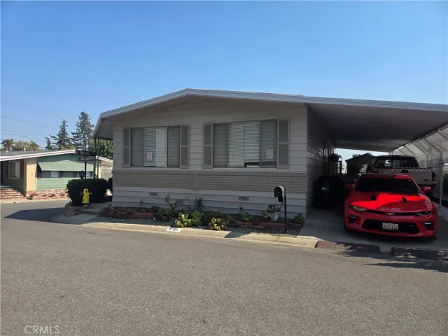 a front view of a house with cars parked