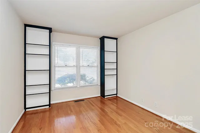 a view of wooden floor and windows in a room