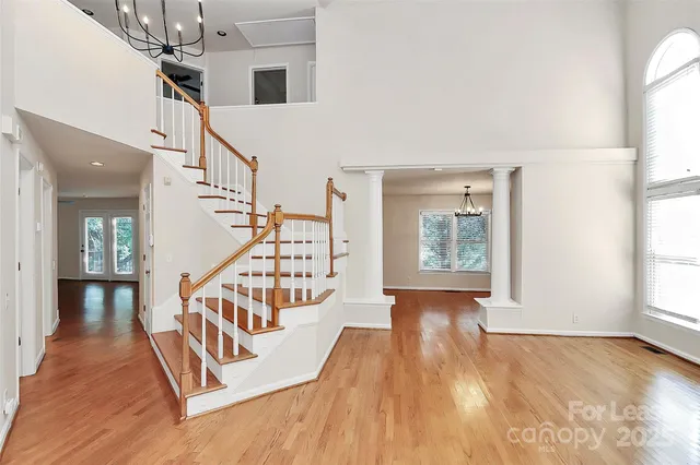 a view of entryway and hall with wooden floor