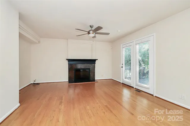wooden floor fireplace and natural light in room