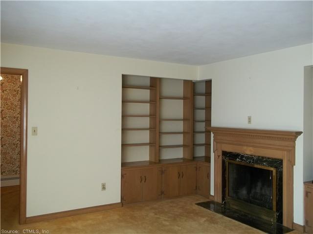 81 Pinecrest Road Orange, CT 06477 - Photo 1 of 1 a living room with a fireplace