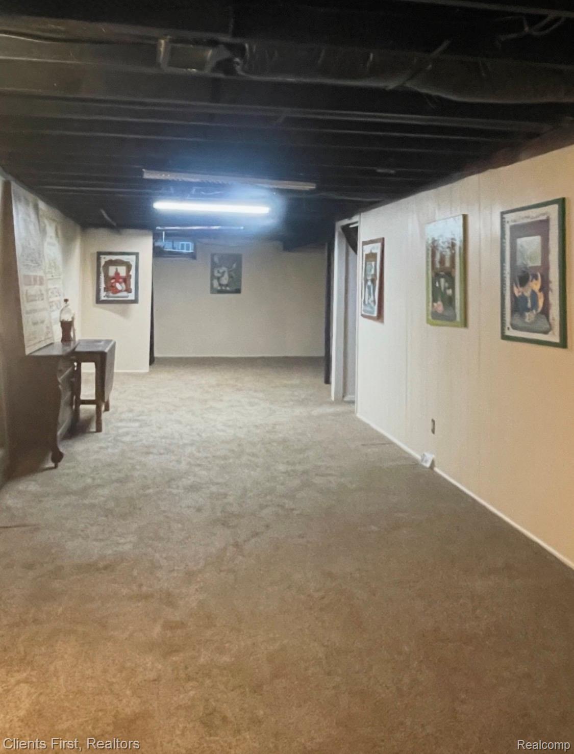 5844 Crandall Road Howell, MI 48855 - Photo 36 of 52 Spacious open-concept lower level with neutral-toned carpeting and light-colored paneled walls