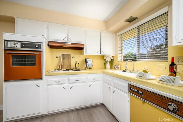 a kitchen with granite countertop cabinets stainless steel appliances a sink and window