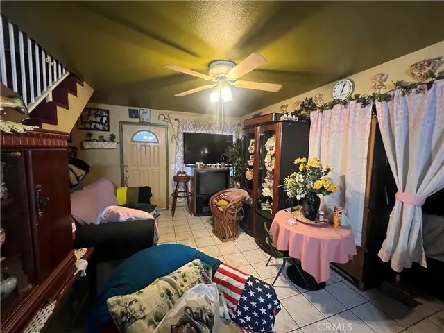 a living room with furniture a rug and a chandelier