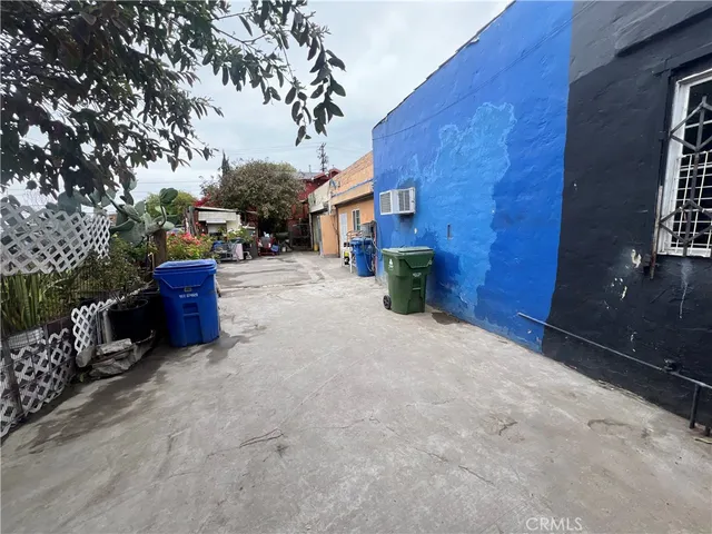 a view of a house with a yard and pathway