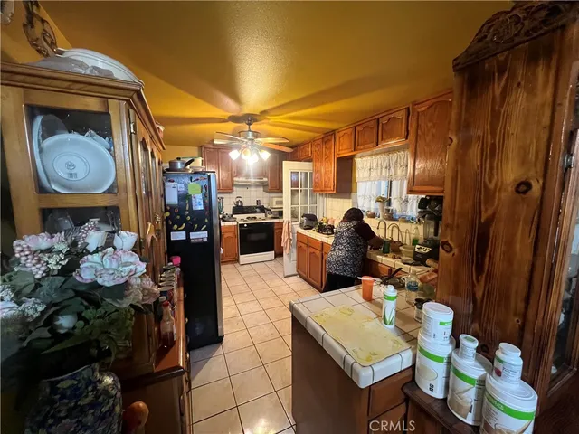 a kitchen with a sink a stove cabinets and a window