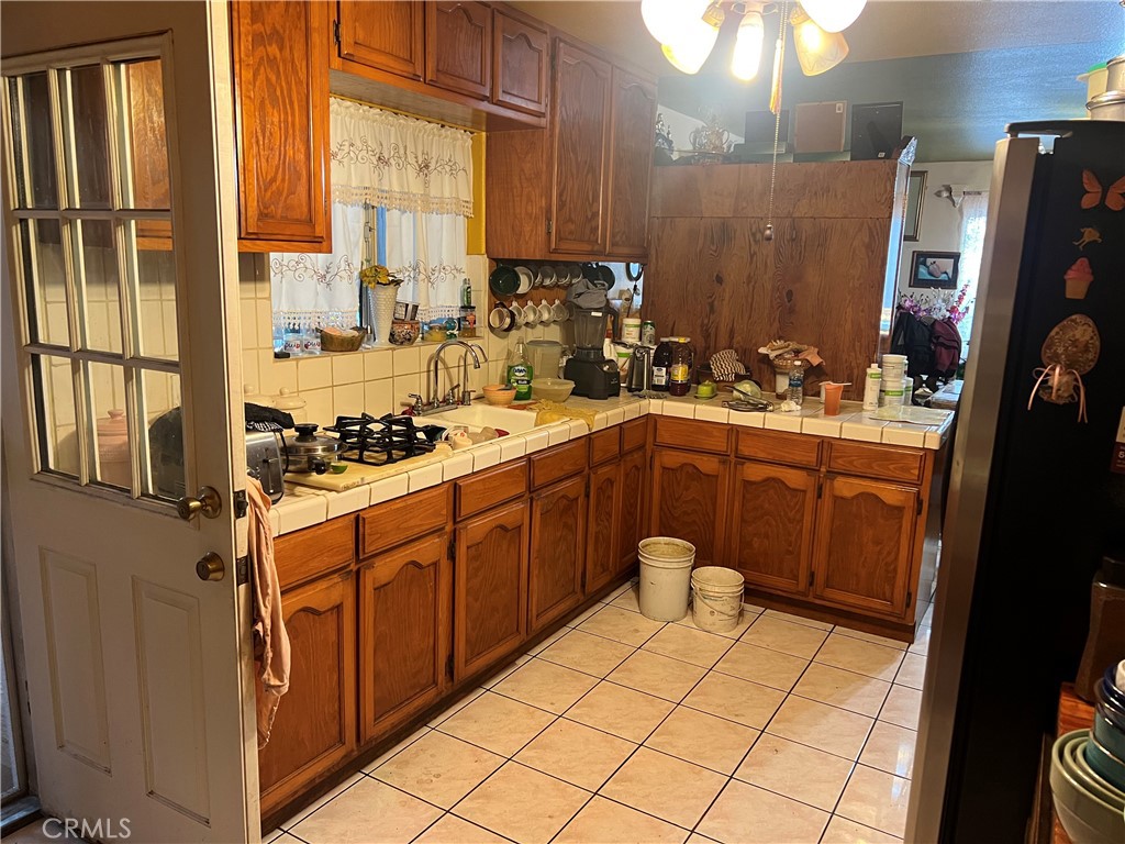 8310 South Broadway Los Angeles, CA 90003 - Photo 8 of 28 a kitchen with a sink a stove cabinets and a window