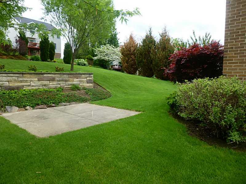 210 Ruth Way McDonald, PA 15057 - Photo 17 of 20 Exterior Back. Professional landscape stone wall and accent patio
