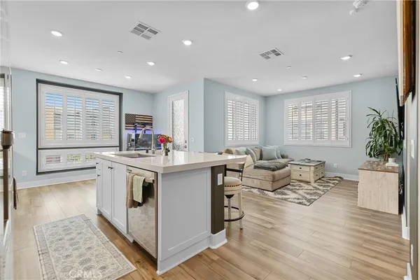 a open kitchen with stainless steel appliances granite countertop a stove and a large refrigerator