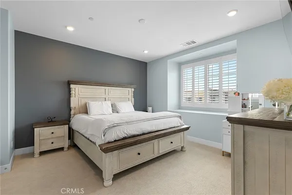 a spacious bedroom with a bed and window