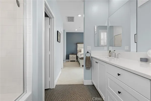 a bathroom with a double vanity sink mirror and toilet