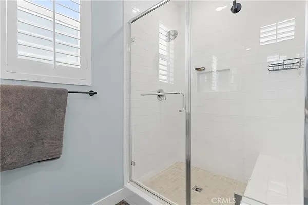 a bathroom with a glass shower door