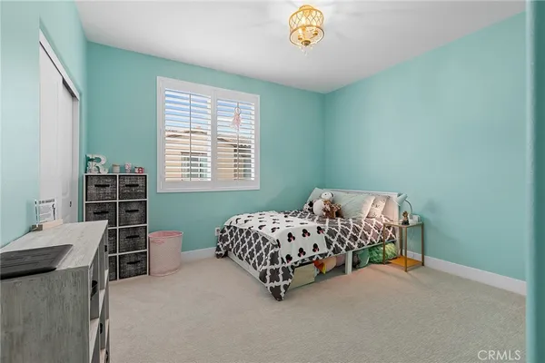 a bedroom with bed and a window