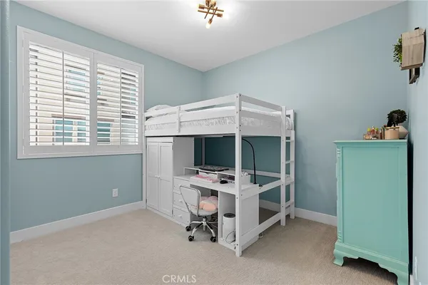 a bedroom with bed and a window