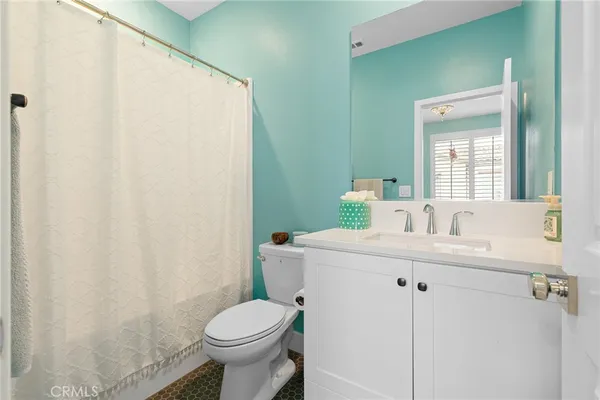 a bathroom with a sink toilet and mirror