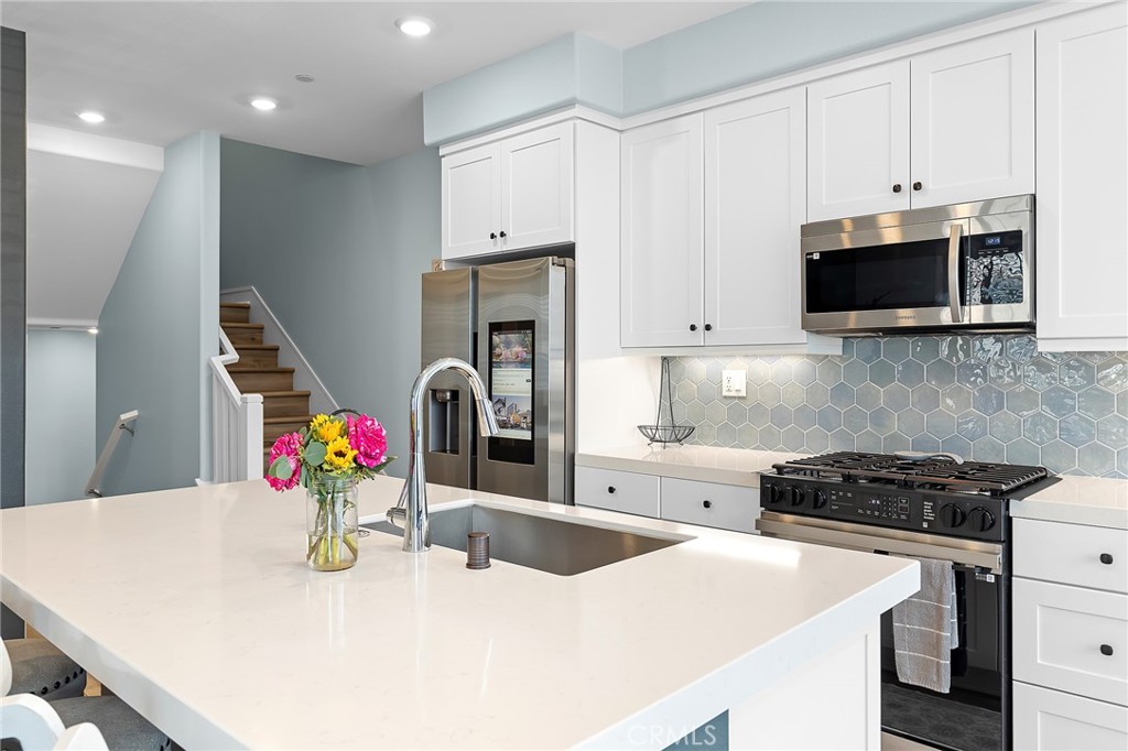 705 Arrowleaf Road Rancho Mission Viejo, CA 92694 - Photo 4 of 48 a kitchen with stainless steel appliances a stove a sink a microwave a refrigerator and cabinets